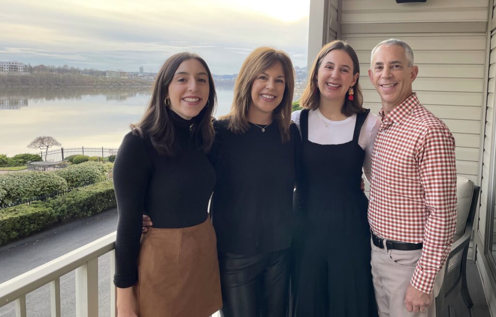 A photograph of three women and a man.